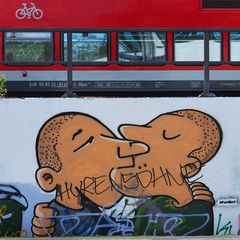 Schriftzug "Hurensöhne" prangt auf einem Graffiti, das küssende Männer zeigt