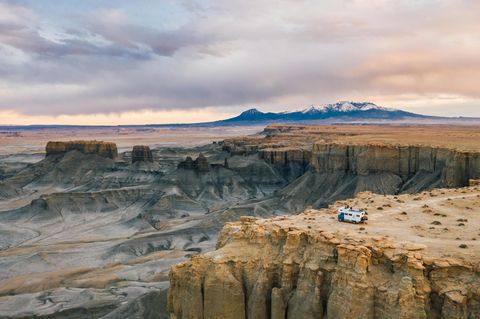 Camper-Van parkt an einer Klippe in rauer Landschaft