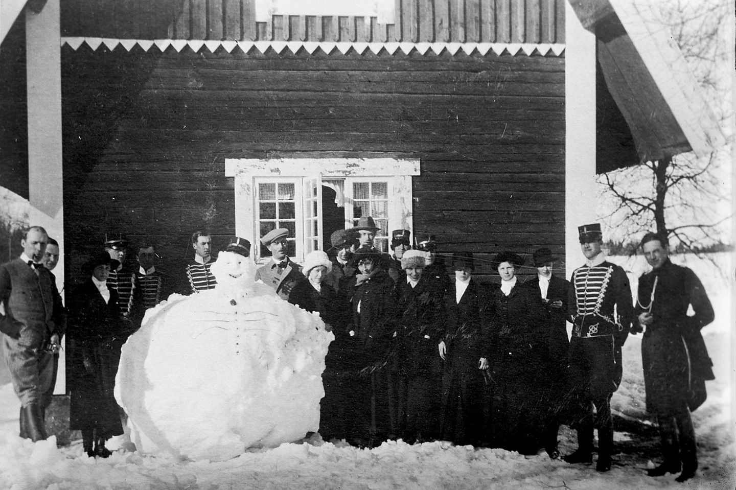 Antreten zum Dienst! Gruppe von Menschen posiert um Schneemann
