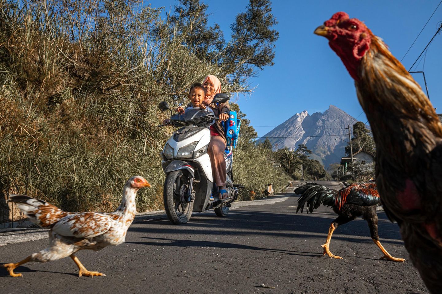 Am Fuß des Feuerberges Merapi Indonesien - eine Frau und ein Junge auf einem Moped