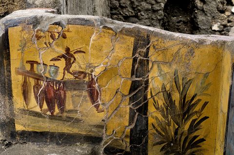 (Handout) The almost intact premises of a Thermopolium, a street food shop, with dishes of all kinds return to light in Pompeii, Italy on december 26, 2020. The newly unearthed thermopolium is noted for its well preserved, colourful frescoes portraying images of geese, a rooster, a dog on a leash and mythological characters. Archaeologists have discovered an inlaid floor of polychrome marble, earthenware pots and have even clues about what was on the menu, with one paella-type dish including a mixture of mammals, birds, fish and snails. This discovery opens up new studies on the life, uses and nutrition of the Pompeians. They also unearthed the skeletons of two men and a dog. The Pompeii archaeological park has announced that it will open up the place to visitors on Easter 2021. Pompeii was buried under 4 to 6 m of volcanic ash and pumice in the eruption of Mount Vesuvius in AD 79. Photo via ABACAPRESS.COM