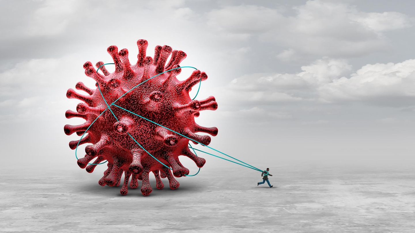 Ein Mann läuft und zieht an Schnüren ein riesiges Virus hinter sich her