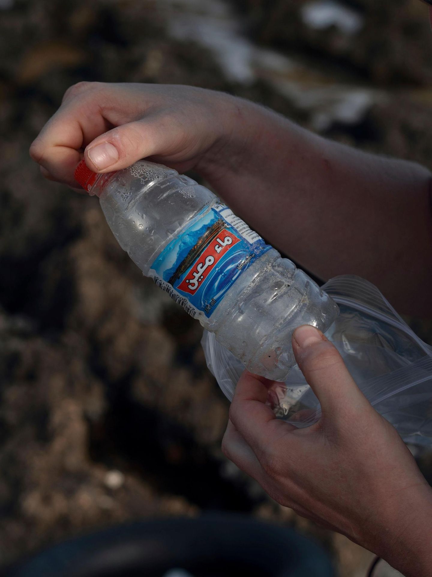 Hände halten Plastikflasche