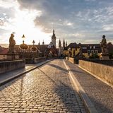 Germany, Bavaria, Wurzburg, Empty Alte Mainbrucke bridge at cloudy sunset