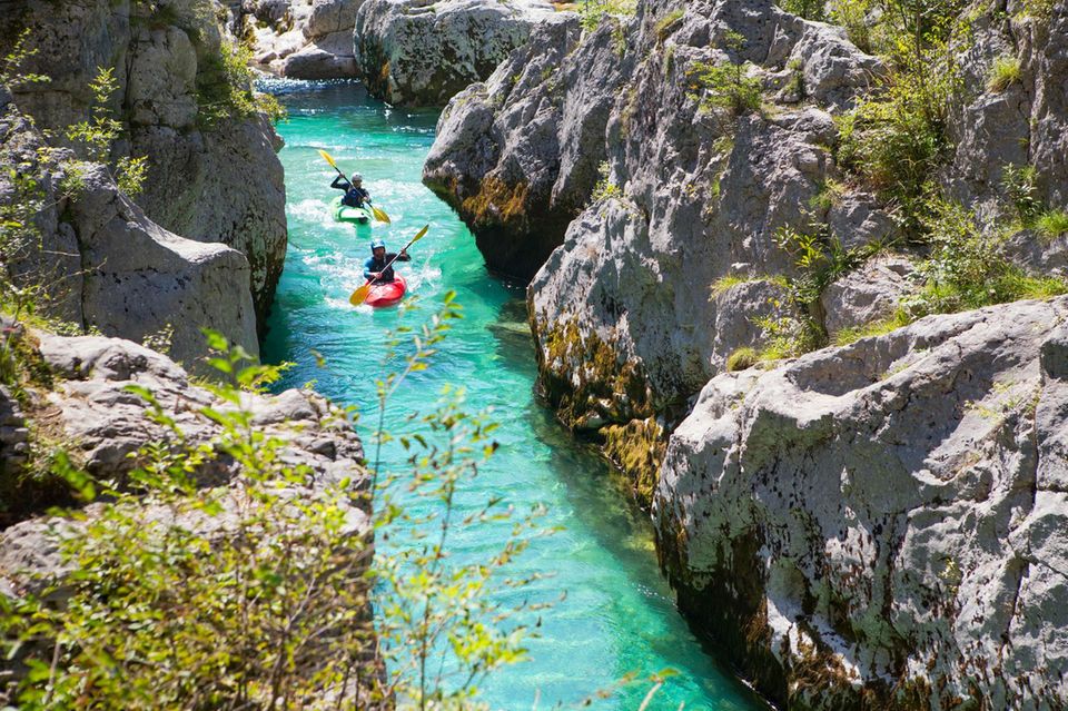 Kayakkers on the emerald Soca near Bovec in Slovenia. This green colored river, originating in the Triglav mountains, is famous for all kinds of white water activities. 1.548