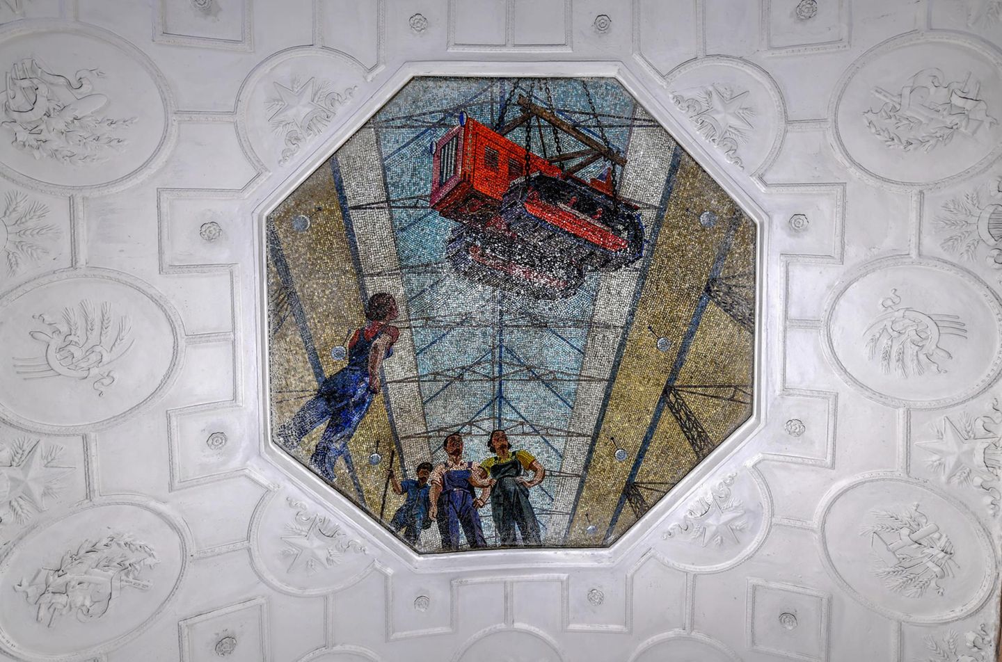 Mosaikbild von Arbeitern, über denen seitlich eine Baumaschine an einem Kranseil hängt