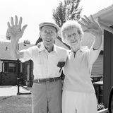 A man and a woman are waving goodbye