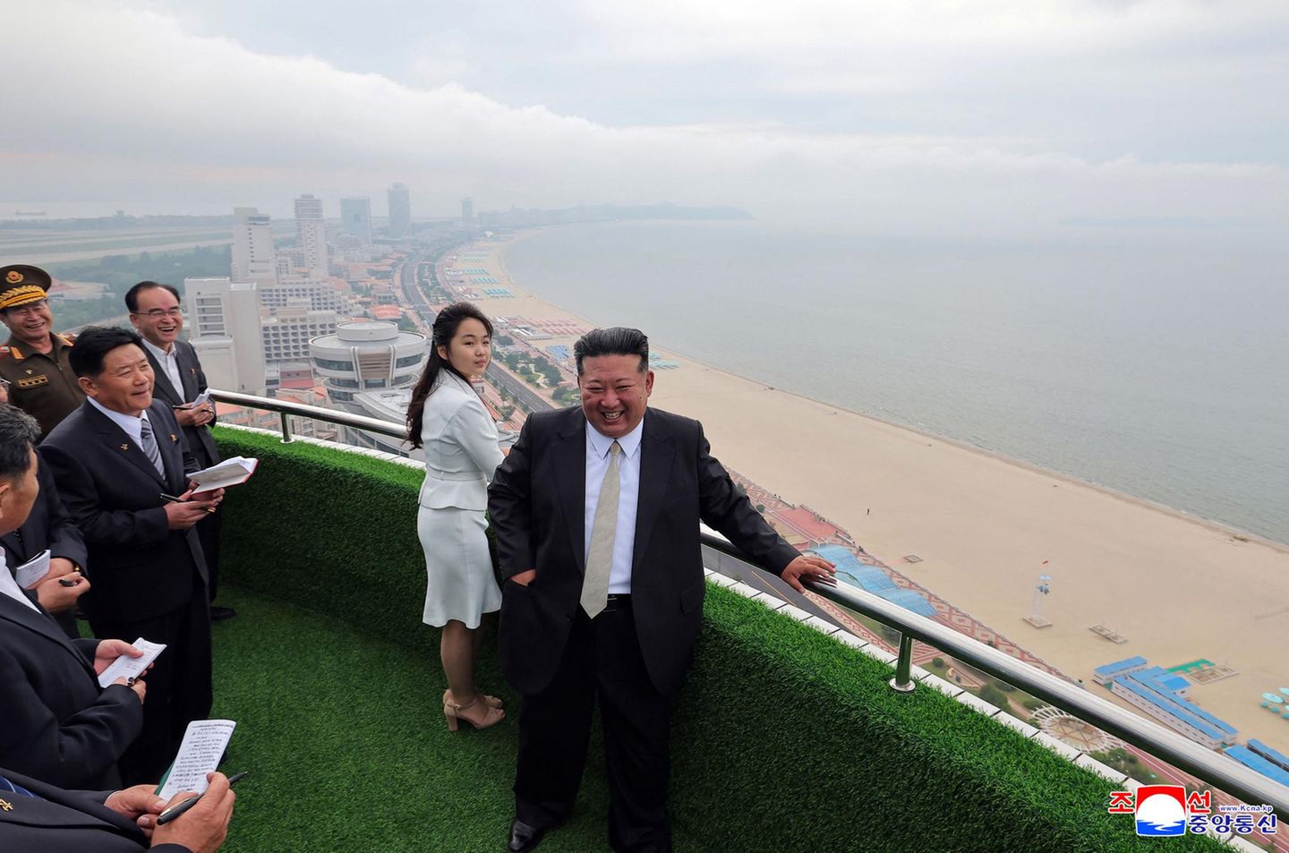 Grinsen für die Kameras Es ist nicht irgendeine Eröffnung. Das gerade fertig gebaute Wonsan-Kalma-Strandressort an der Ostküste Nordkoreas soll laut staatlicher Nachrichtenagentur eine neue Ära des Tourismus für das Land einleiten und sei "die Frucht des tiefgründigen Denkens des verehrten Genossen Kim Jong Un." Der Diktator kam auch selbst mit seiner Ehefrau und seiner Tochter zur Eröffnung.