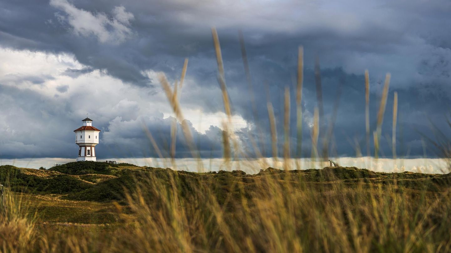 Wattwandern: Zu Fuß nach Langeoog Wolkiger Himmel und Wasserturm auf der Insel Langeoog