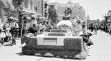 Ein Wagen mit Schneewittchen und den sieben Zwergen fährt durch Disneyland