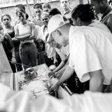 Menschenmenge um einen offenen Sarg