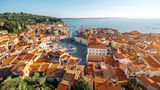 Beautiful aerial view on Piran town with Tartini main square, ancient buildings with red roofs and Adriatic sea in southwestern Slovenia