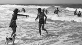 Personen baden im Meer