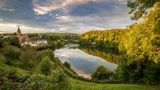Elevated view of the Ulmener Maar and its shores, with the village of Ulmen at sunset, a volcanic lake and crater part of the Eifel National Park (Vulkaneifel) on the German volcanic route, an UNESCO Geopark, Daun - Rhineland-Palatinate - Germany.