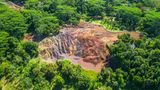 Eine Luftaufnahme der Siebenfarbigen Erde auf Mauritius, bei dem sich die bunte Landschaft vom umgebenden Wald abhebt