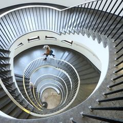 Person läuft durch rundes Treppenhaus