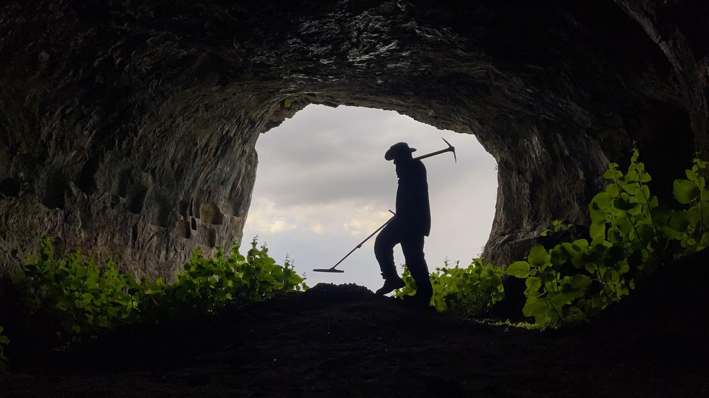 Schatzsucher mit Metalldetektor sucht in der Höhle