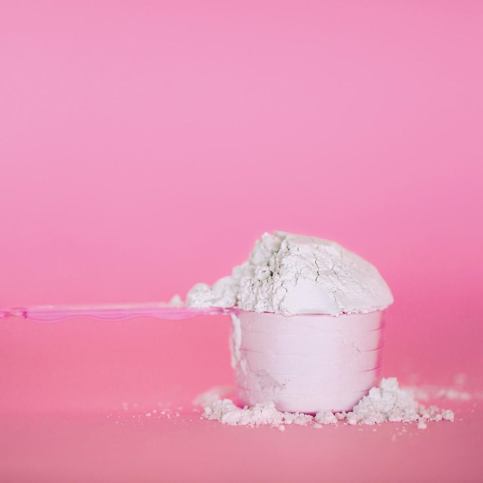 Proteinpulver auf pinkem Untergrund