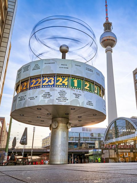 Long term exposure, panoramic view on the Urania World Clock in Berlin and TV Tower on the Alexander Square,  a tourist attraction and meeting place