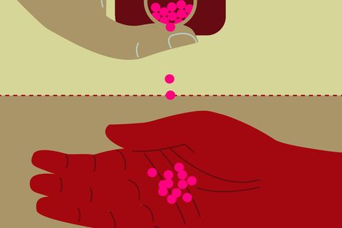 Person pouring pills into hand