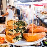 PALERMO, ITALY: Spinach pie, grilled vegetables, local street snacks on stall of traditional food market on 10 October 2019. Sicily is Italian region with highest number of expatriates