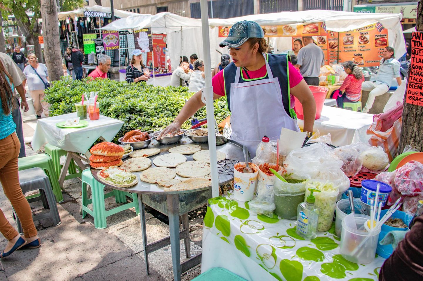 Mexico City, Mexico, Woman preparing Mexican food in a weekend market on a Saturday in  Alameda Central Park.