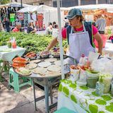 Mexico City, Mexico, Woman preparing Mexican food in a weekend market on a Saturday in  Alameda Central Park.
