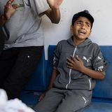 Ein Junge hält sich die Hand an die Brust, er weint