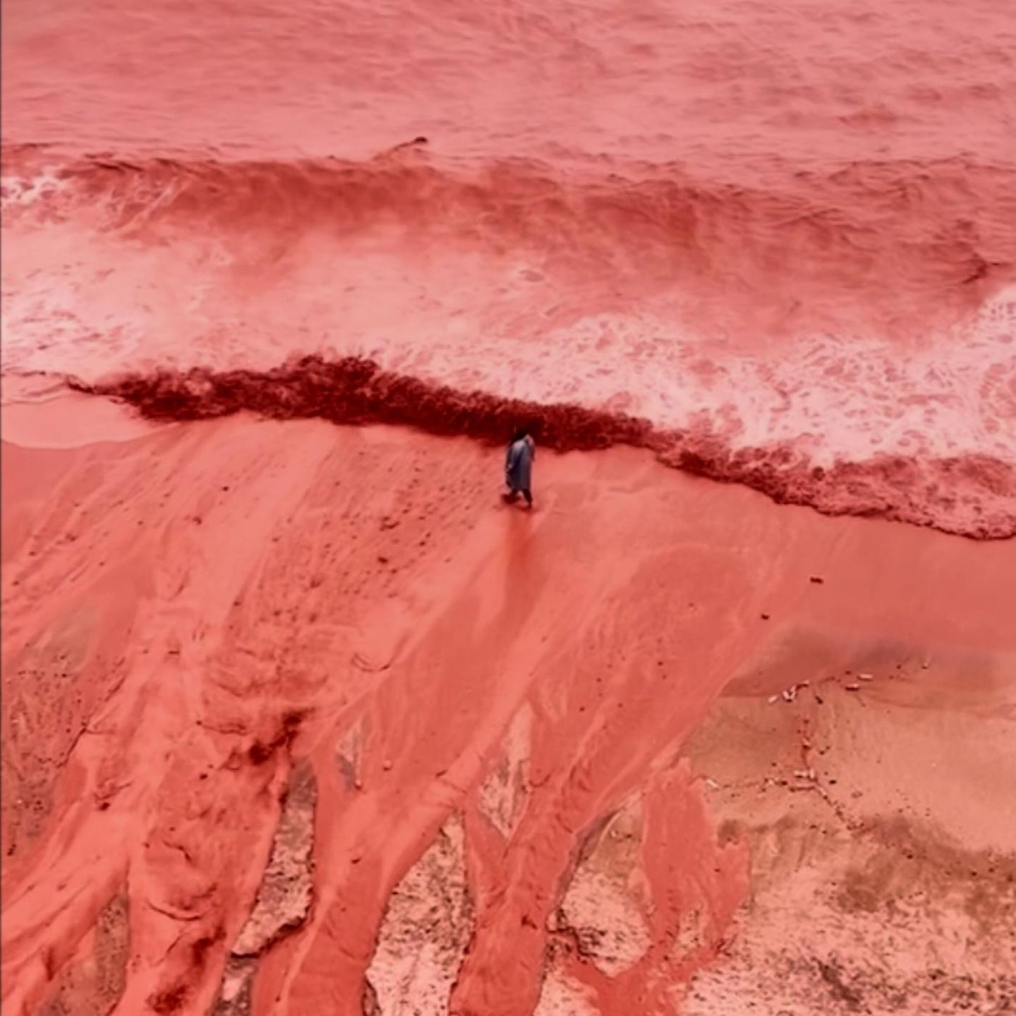 This picture, taken from video, shows how rainfall briefly transforms the coastline of its famed Red Beach into a striking natural scene on Iran's Hormuz Island, Tuesday Dec. 16, 2025