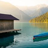 Ein Bootshaus am Morgen bei Sonnenaufgang am Plansee, Österreich