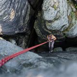 Eine Person in einer Felsspalte am Kletterseil