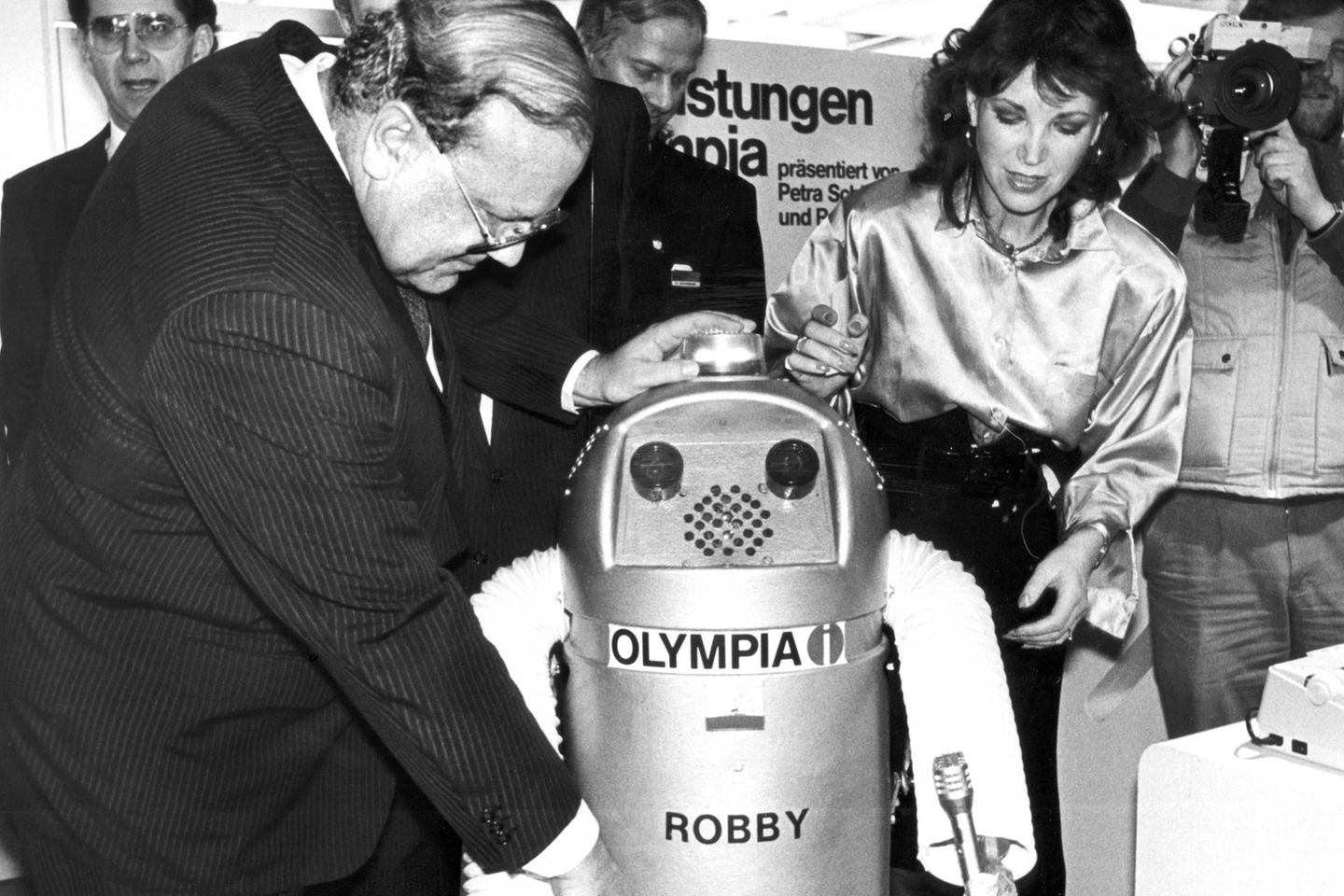 Bundeswirtschaftsminister Martin Bangemann und die ehemalige Miss World, Petra Schürmann schauen auf einen Roboter