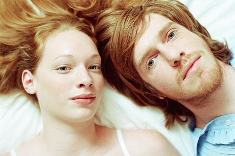 Junges Paar liegt Kopf an Kopf