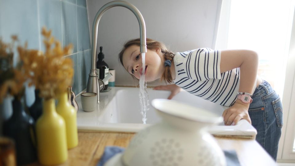 Ein Kind trinkt Leitungswasser, das möglicherweise mit PFAS belastet ist.