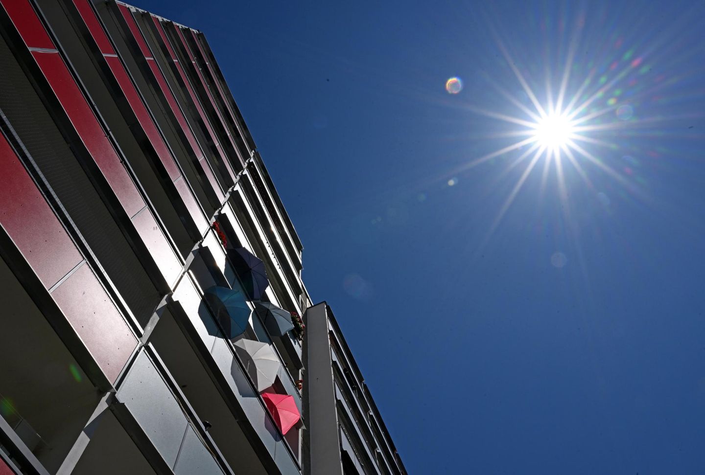 Eine Gebäudefassade und die strahlende Sonne