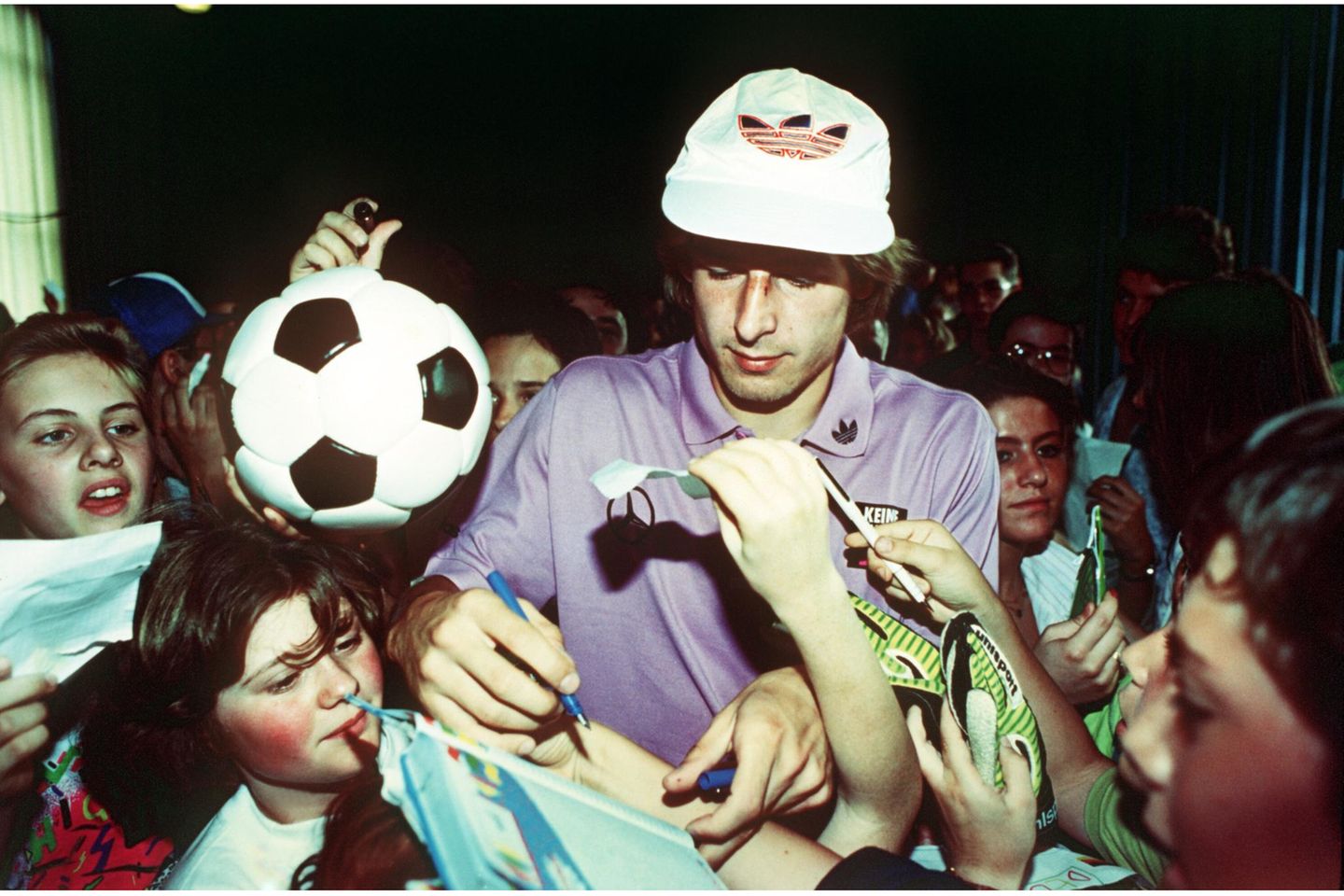 Für einen Moment rücken das anstehende Viertelfinale, der Druck eines ganzen Fußballlandes und der Medienrummel in den Hintergrund. Jürgen Klinsmann schreibt am 28. Juni 1990 Autogramme für die Schülerinnen und Schüler der deutschen Schule in Mailand. Die DFB-Elf krönt das Turnier in Italien schließlich mit einem 1:0 im Finale gegen Argentinien – dem ersten WM-Titel eines vereinten Deutschlands.